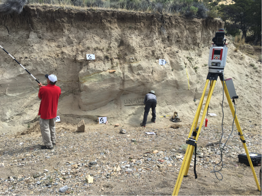 Terrestrial laser scanner in the right foreground. Background has structure from motion (SfM) ground control targets. Participant in red is taking SfM pictures from a pole platform. Participant in gray is testing change detection sensitivity through building cairns and removing sand.