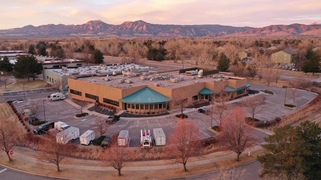 photo of UNAVCO office building with front range mountains in the background