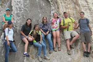 eight undergraduate students by rock outcrop