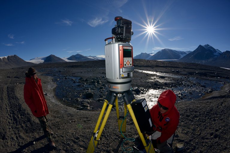 Taken with a fish-eye lens, this image has the TLS image up close in the foreground while Marianne Okal works on the instrument and Steven Crisp stands near by.