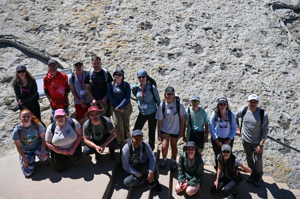 group photo in front of dinosaur tracks