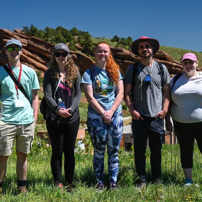The five 2021 USIP interns standing in a line at Red Rocks Park in Morrison, CO.