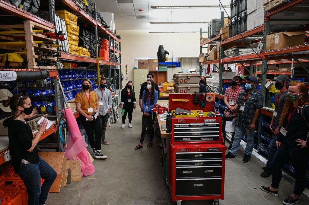 interns gathered in workshop area on tour