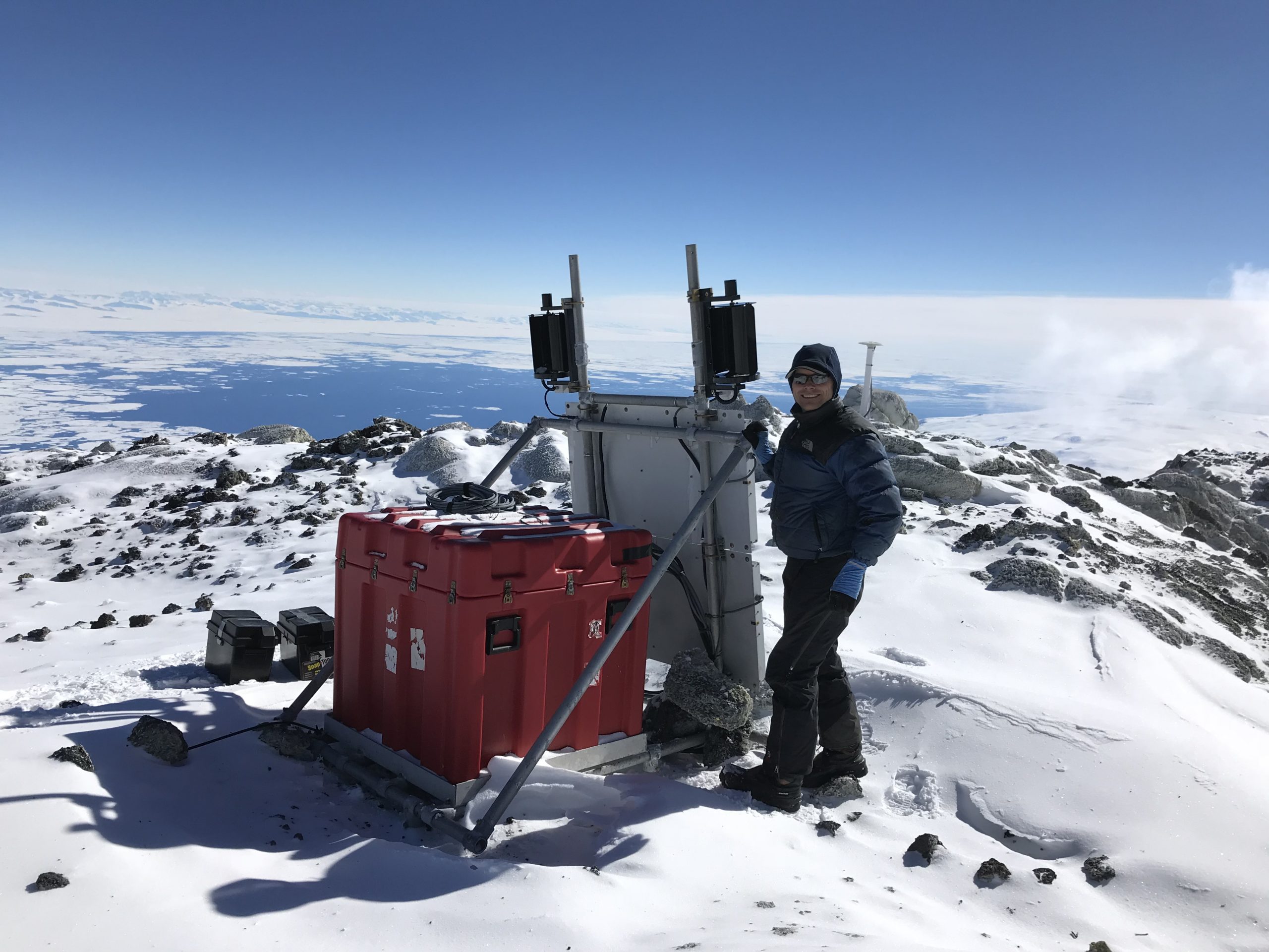 Thomas Nylen works on a GPS station on the slopes of Mount Erebus in Antarctica.