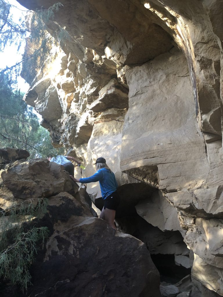 Skye Fernandez (RESESS) climbing an outcrop.