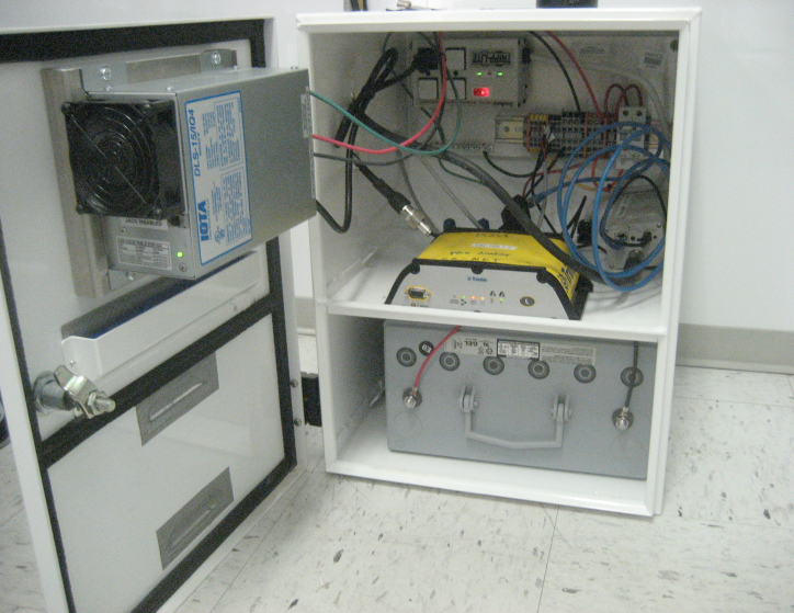 inside of enclosure with wiring and batteries
