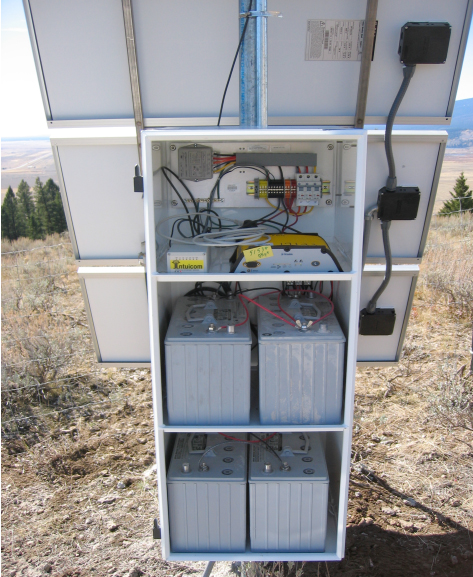 solar panel with back enclosure opened, 4 batteries and wiring visible