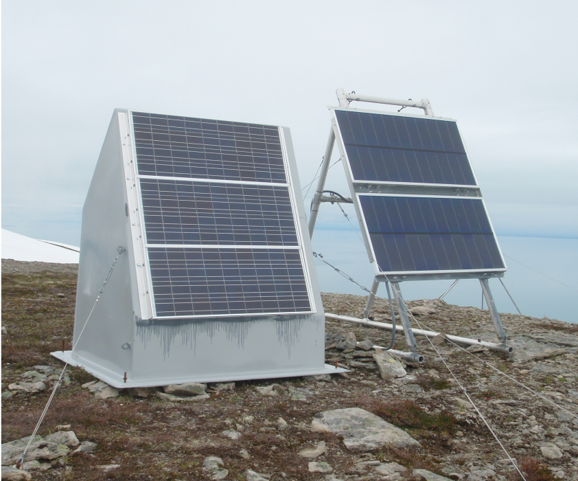 solar panel next to hut with solar panels and battery enclosure