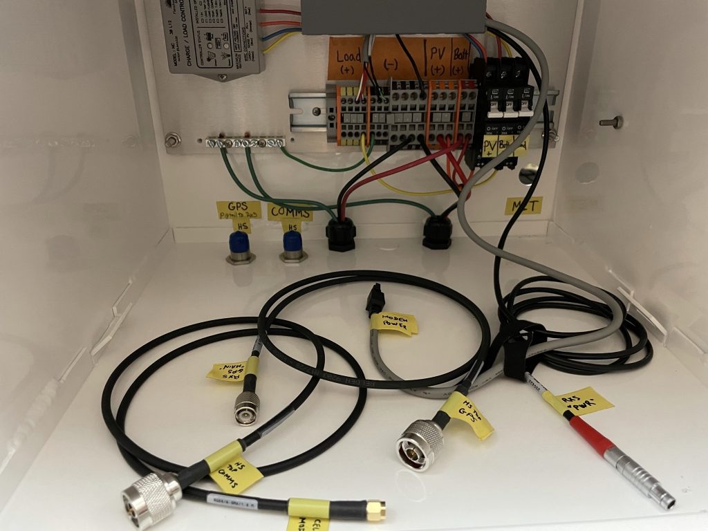 labeled cables and connections inside permanent station box