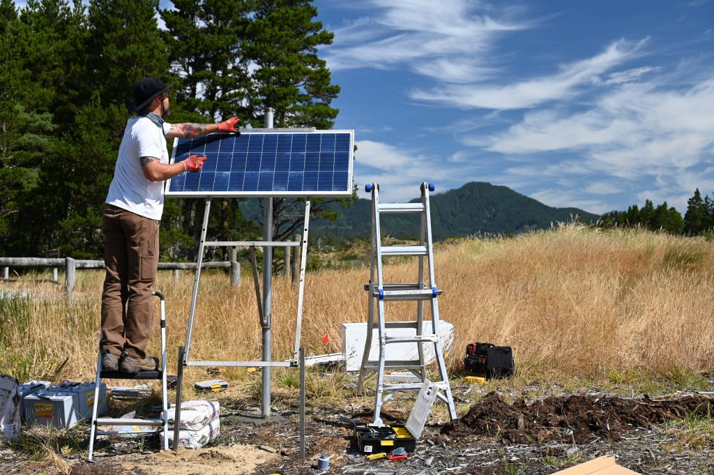 man attaches solar panel