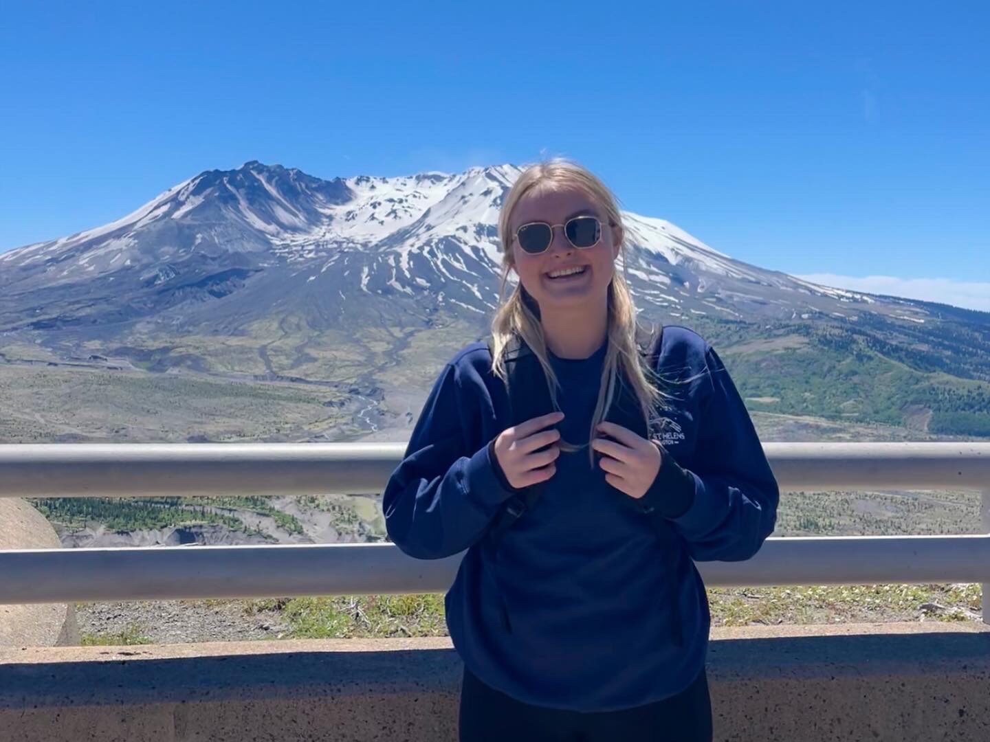 RESESS Satellite Intern Courteney Pike smiles in front of Mount St. Helens on the field trip led by the University of Washington in June, 2022.